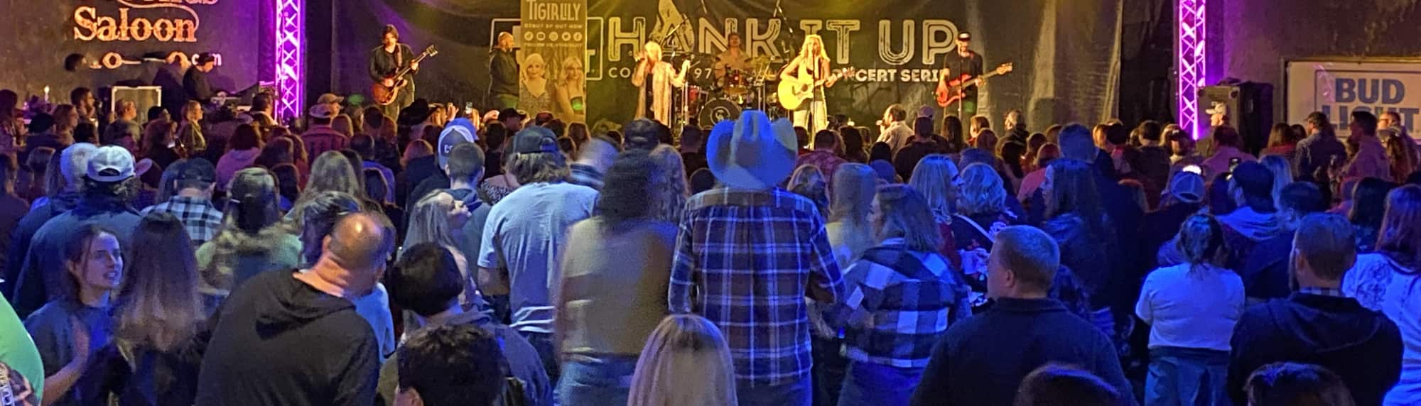 country concert with fans wearing cowboy hats Green Bay